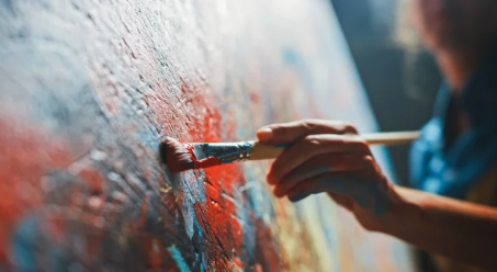 Close up of artist hand and paintbrush painting