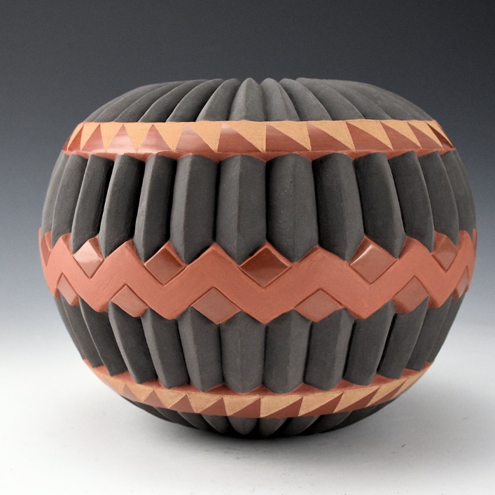 Jared Tso with ceramic pots in front of saguaro cactuses